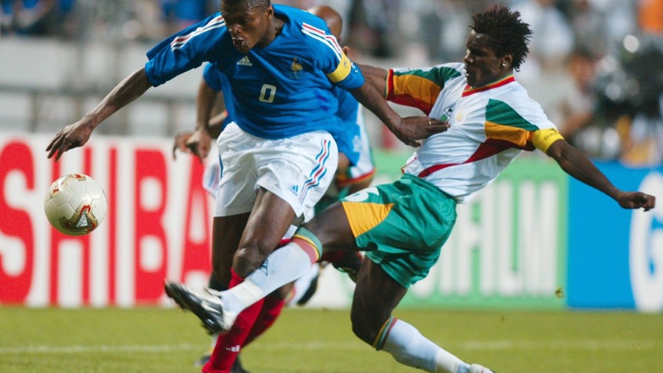 جام جهانی 2002|مارسل دسایی از تیم ملی فرانسه برابر آلیو سیسه از سنگال مقاومت می کند.