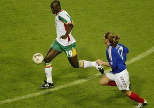 جام جهانی 2002|سئول، 31 می: پاپا بوبا دیوپ (چپ) از سنگال توسط امانوئل پتی تعقیب می شود. گروه A جام جهانی، ورزشگاه سئول، سئول، کره جنوبی، 31 می، 2002، سنگال 1-0 به پیروزی رسید.