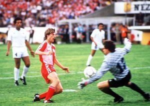 جام جهانی 1986|مایکل لادروپ از دانمارک به سمت دروازه اروگوئه شلیک می کند اما توسط فرناندو آلوز دروازه بان، بلوکه می شود، گروه E جام جهانی 1986 مکزیک. دانمارک 6-1 به پیروزی رسید، لادروپ یکی از گل ها را به ثمر رساند.