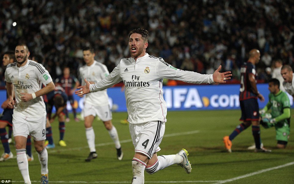 Ramos peels away and raises his arms in celebration while Karim Benzema (left) jogs behind.jpg