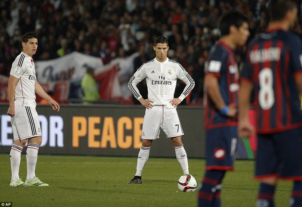 Real Madrid star Cristiano Ronaldo eyes the ball while team-mate James Rodriguez (left) watches.jpg